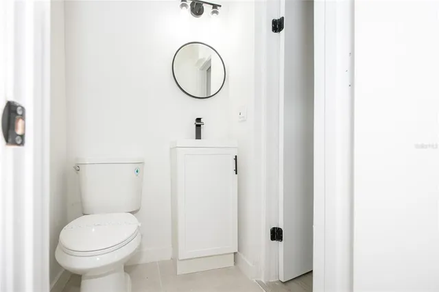 a bathroom with a toilet and a mirror