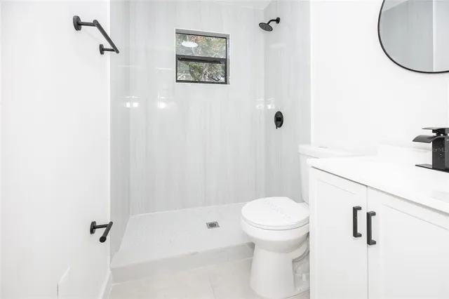 a bathroom with a toilet and a shower