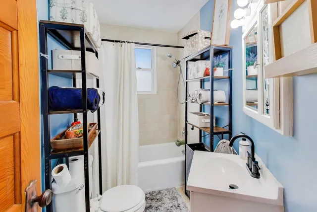 a bathroom with a sink toilet and shower