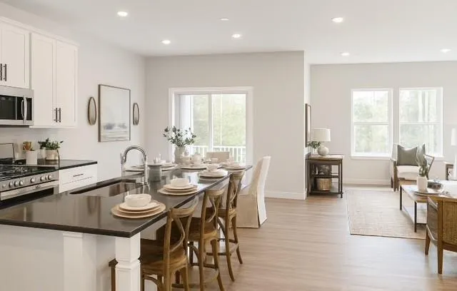 a view of a dining room with furniture and wooden floor