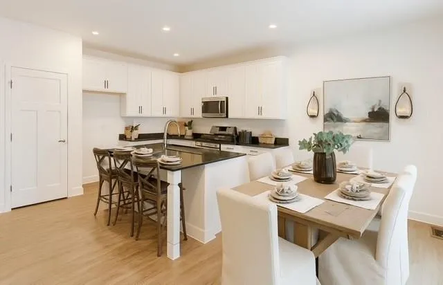 a kitchen that has a table and chairs in it