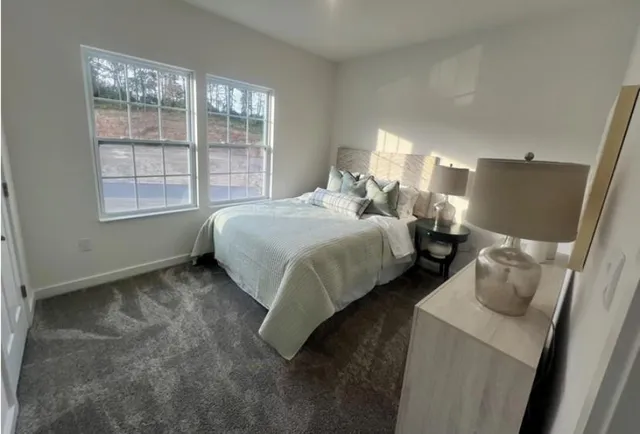 a large bed sitting in a bedroom next to a window