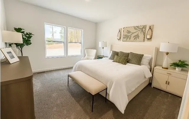 a bedroom with a bed and a painting on the wall