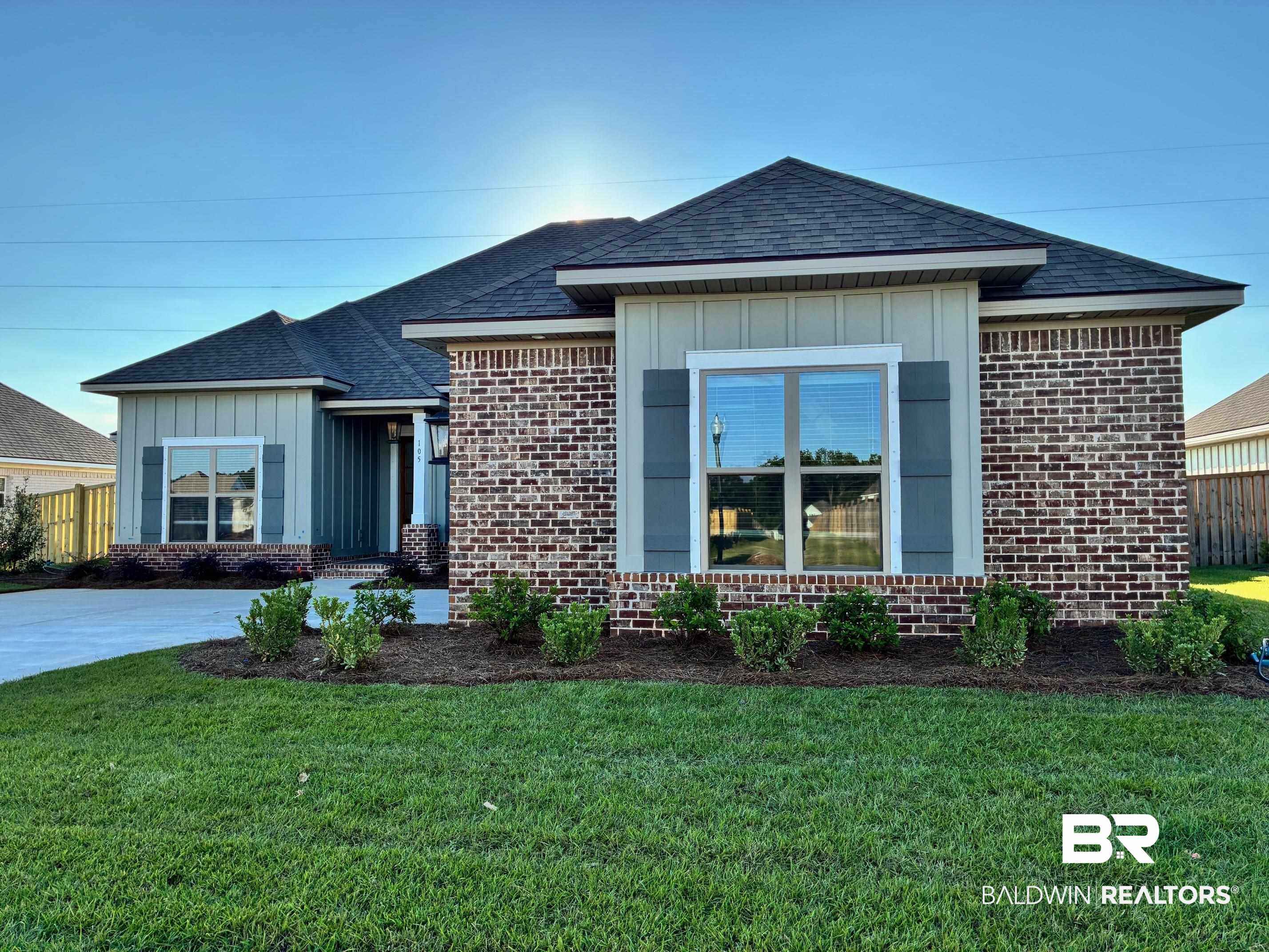 105 Bennington Avenue Fairhope, AL 36532 - Photo 1 of 61 Ranch-style home with board and batten siding, a shingled roof, and brick siding