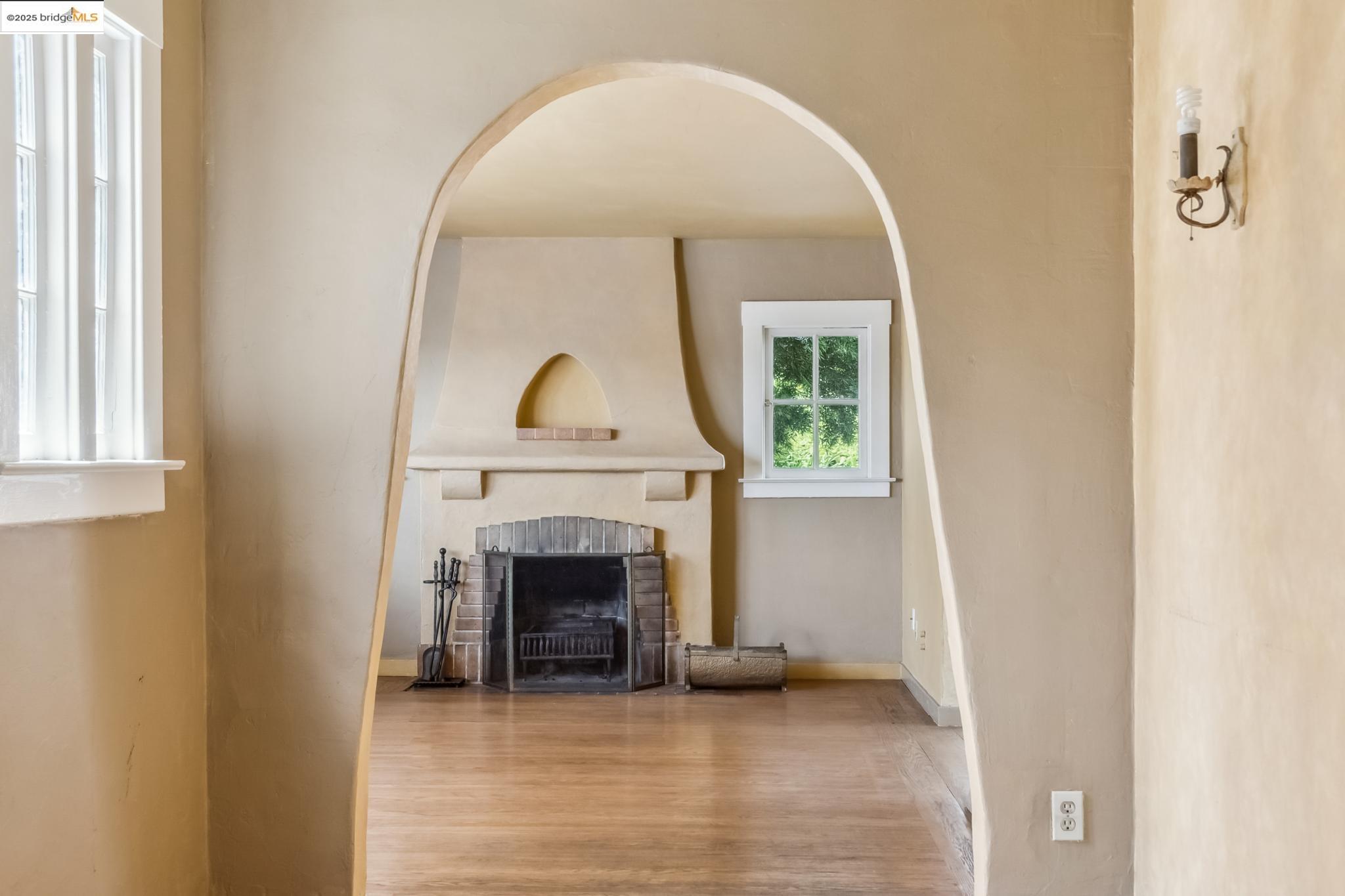 a view of a livingroom with a fireplace and window