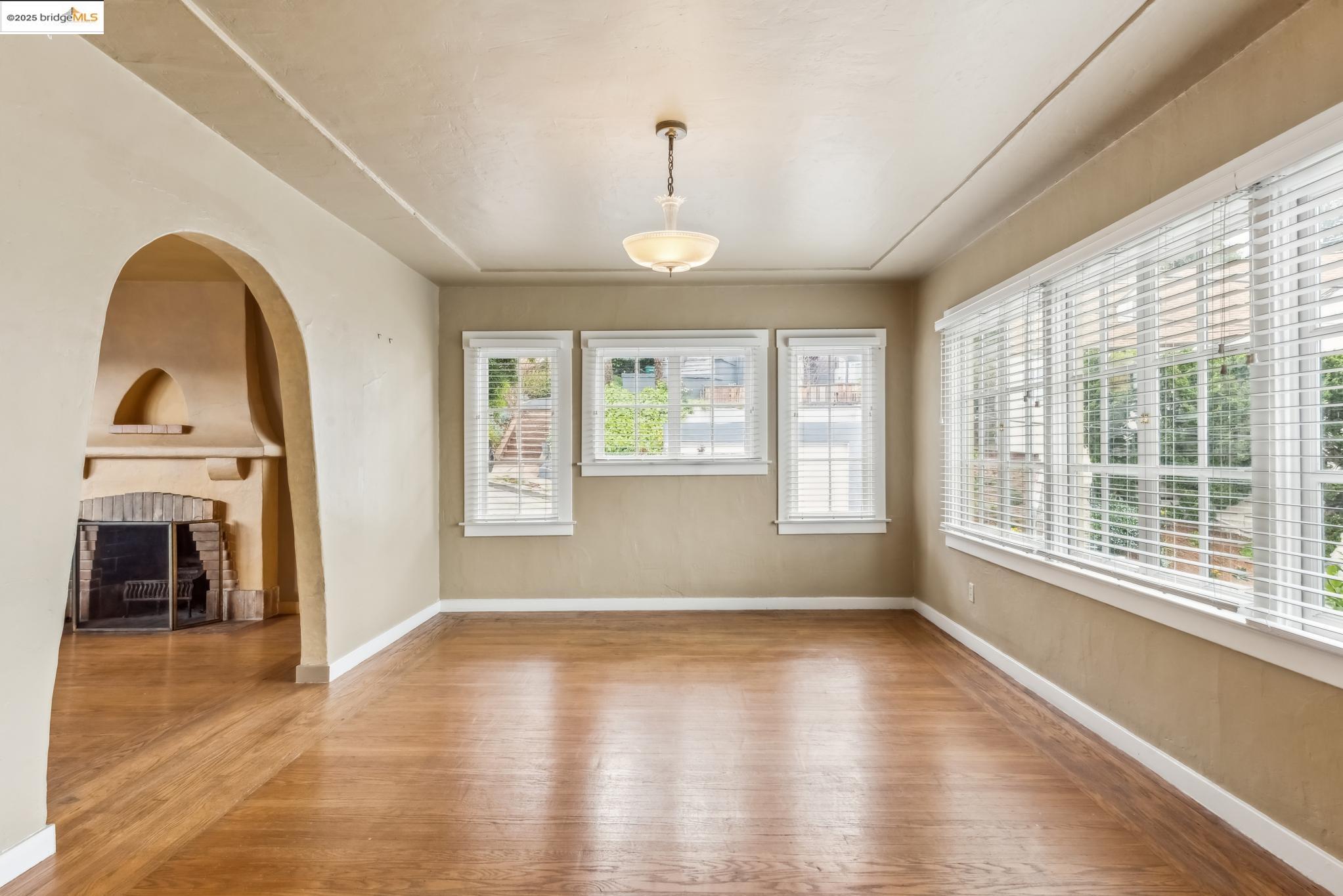 Undisclosed Address Oakland, CA 94610 - Photo 11 of 34 a view of an empty room with window and wooden floor