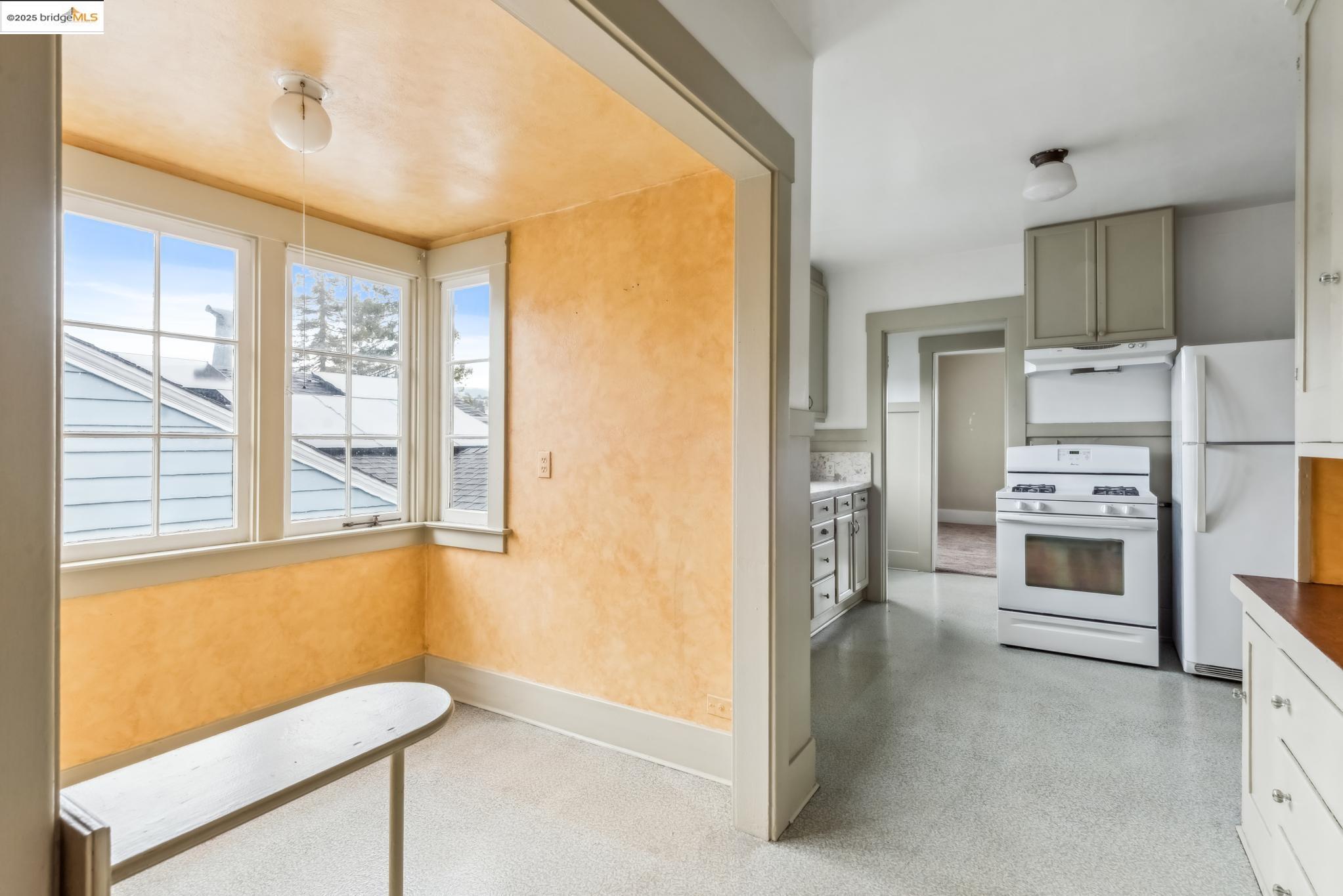 Undisclosed Address Oakland, CA 94610 - Photo 13 of 34 a kitchen with a refrigerator and a stove