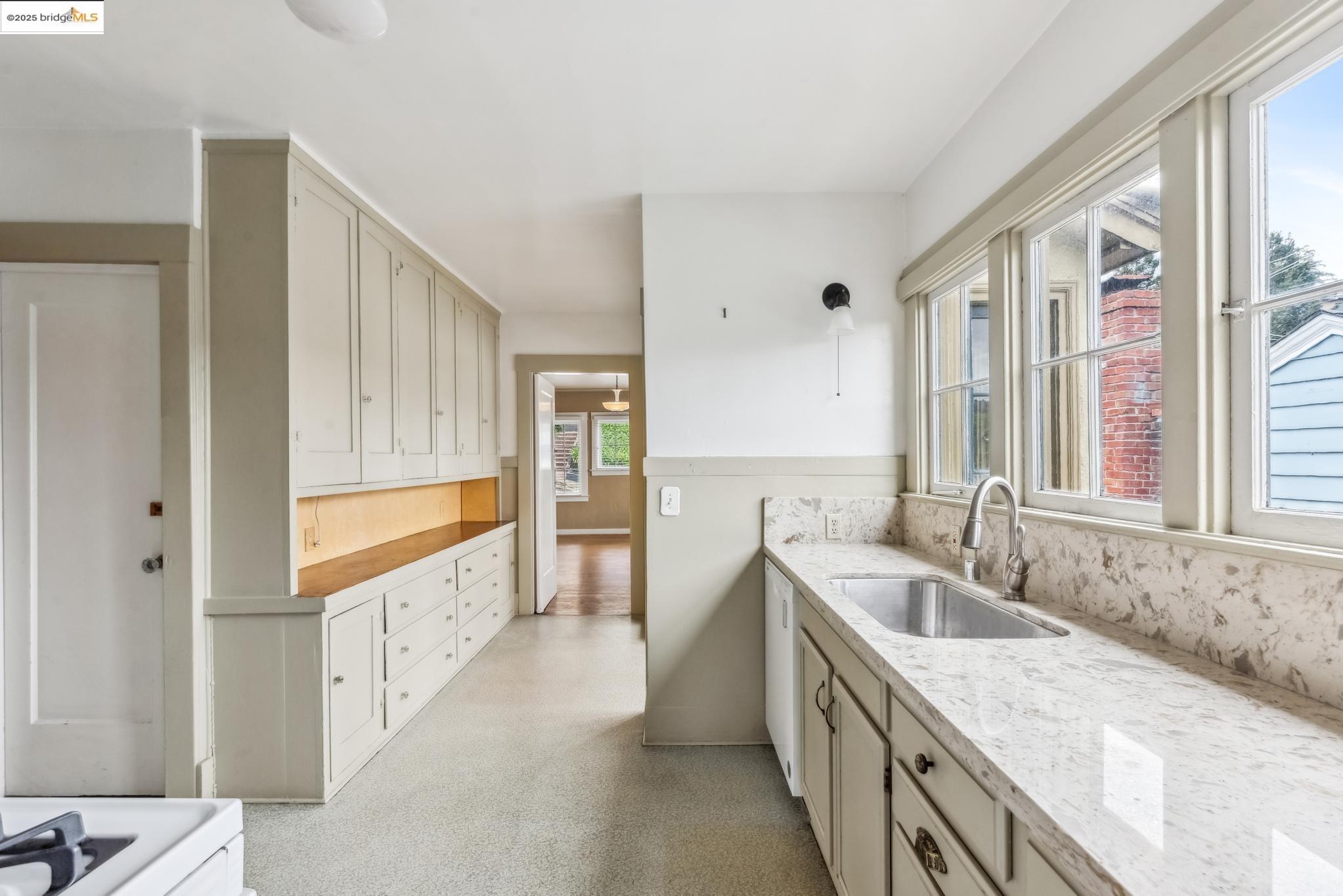 Undisclosed Address Oakland, CA 94610 - Photo 15 of 34 a bathroom with a granite countertop sink and a large mirror