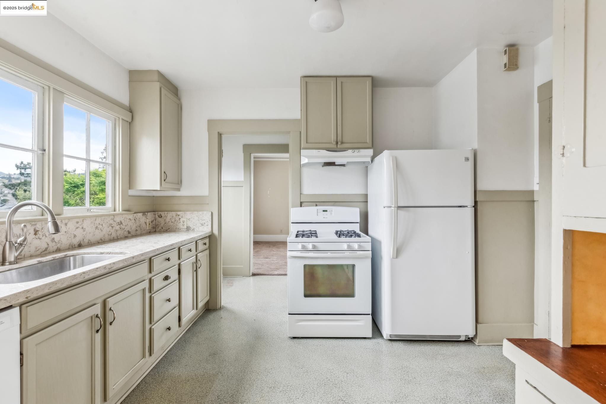 Undisclosed Address Oakland, CA 94610 - Photo 18 of 34 a kitchen with refrigerator a stove a sink and a refrigerator