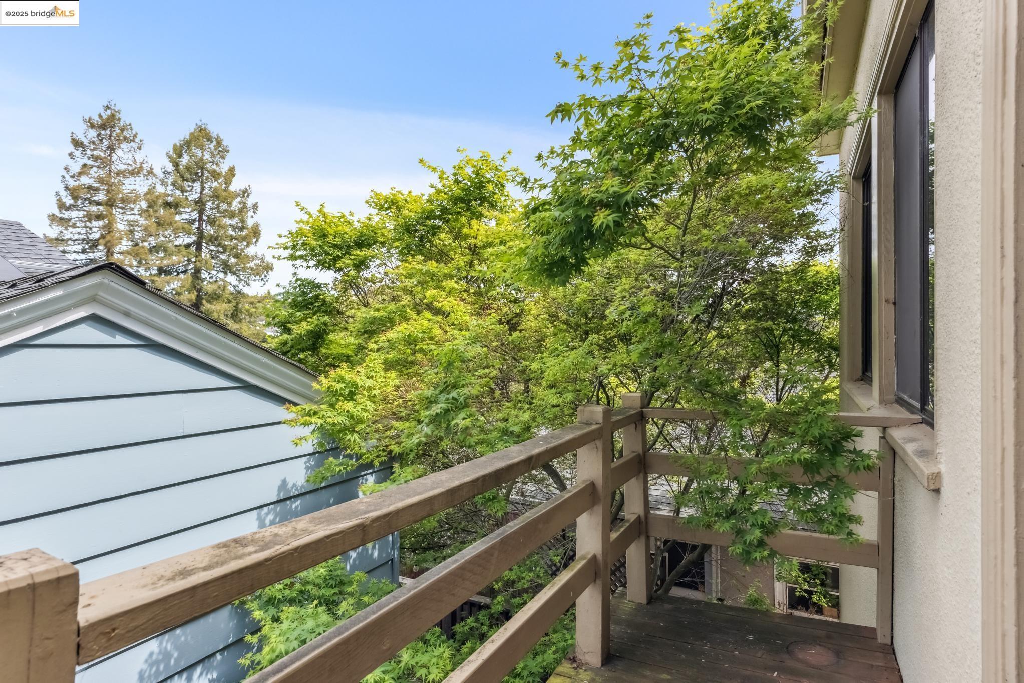 Undisclosed Address Oakland, CA 94610 - Photo 20 of 34 a view of a wooden balcony and trees