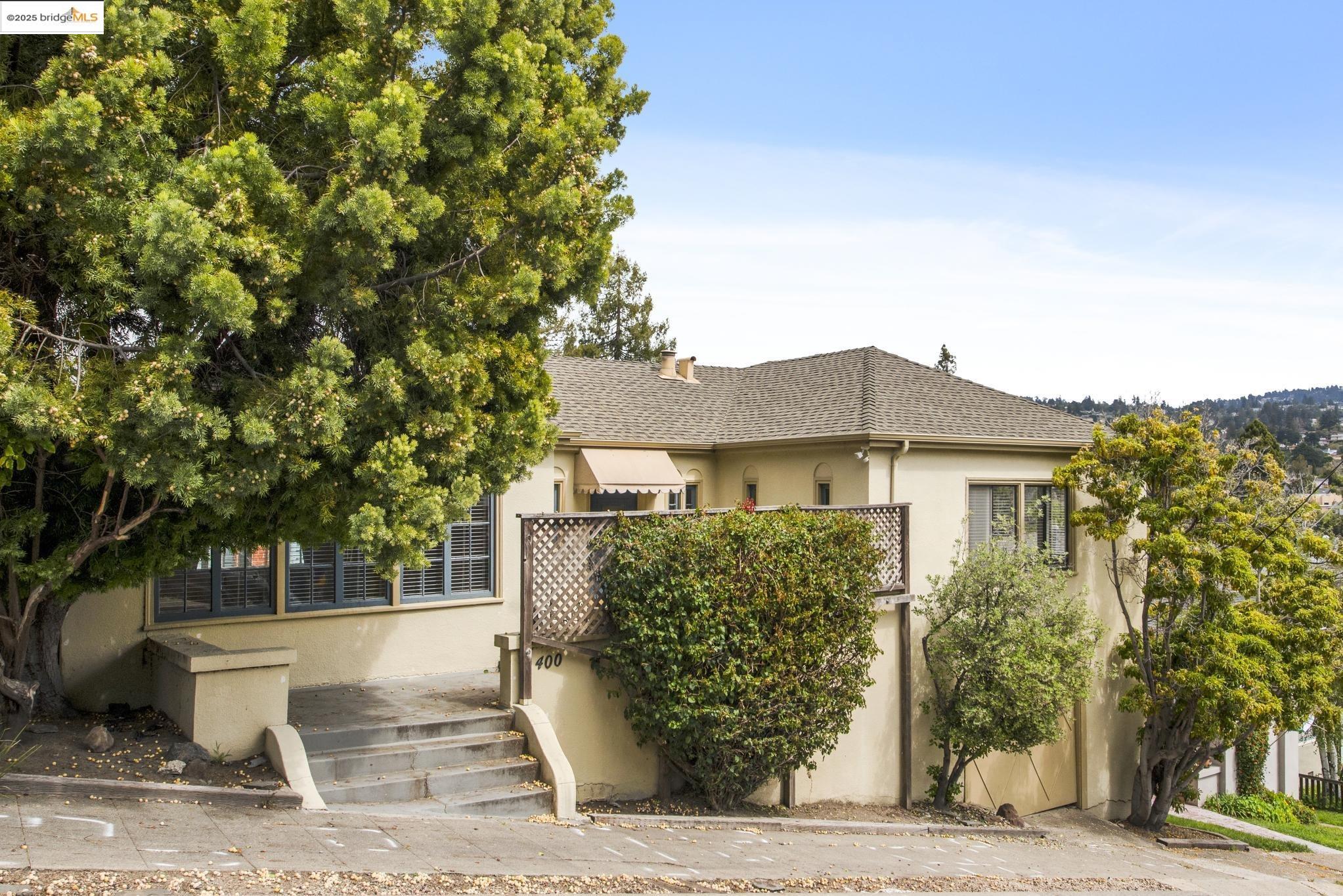 Undisclosed Address Oakland, CA 94610 - Photo 2 of 34 a view of a house with a tree