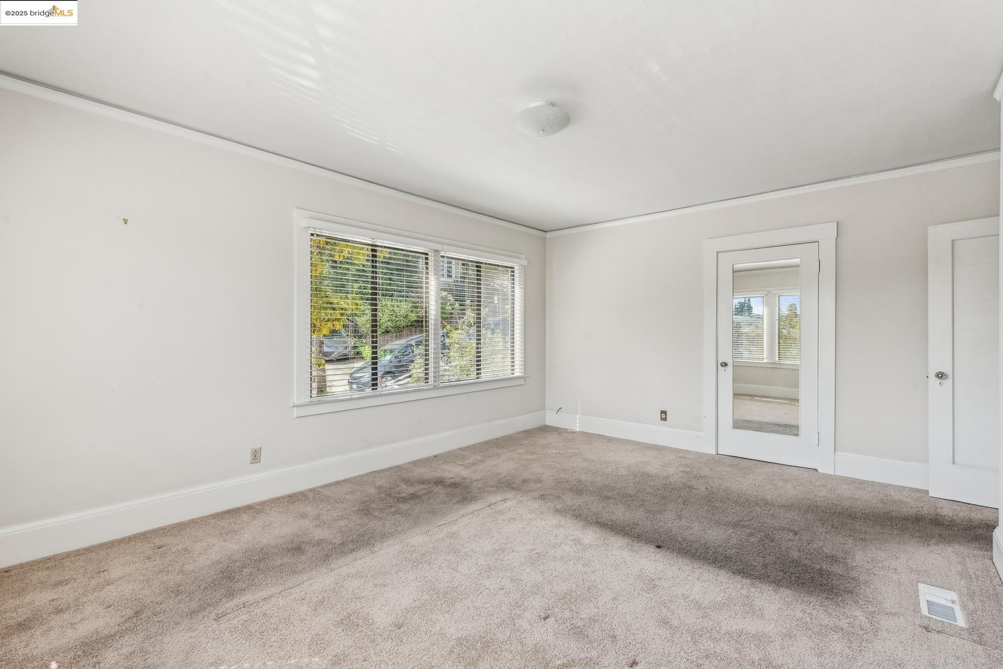 Undisclosed Address Oakland, CA 94610 - Photo 24 of 34 a view of an empty room with a window