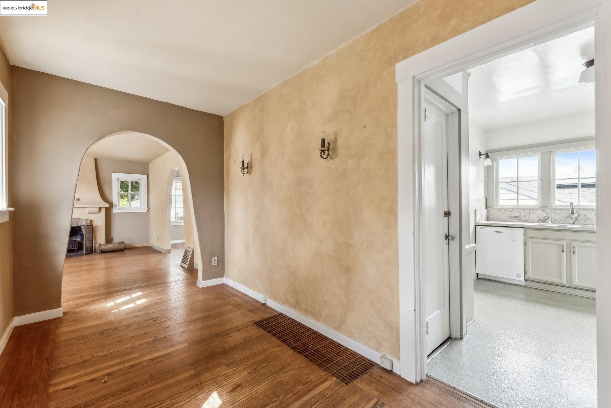 Undisclosed Address Oakland, CA 94610 - Photo 7 of 34 a view of a hallway with wooden floor windows and a living room