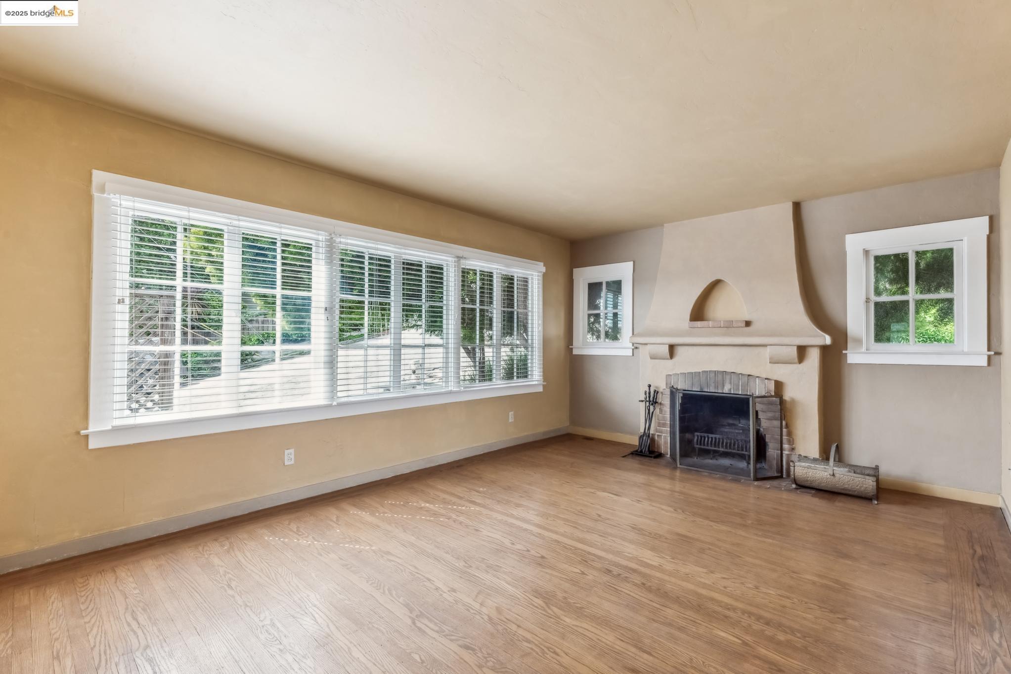 Undisclosed Address Oakland, CA 94610 - Photo 8 of 34 an empty room with furniture and a fireplace