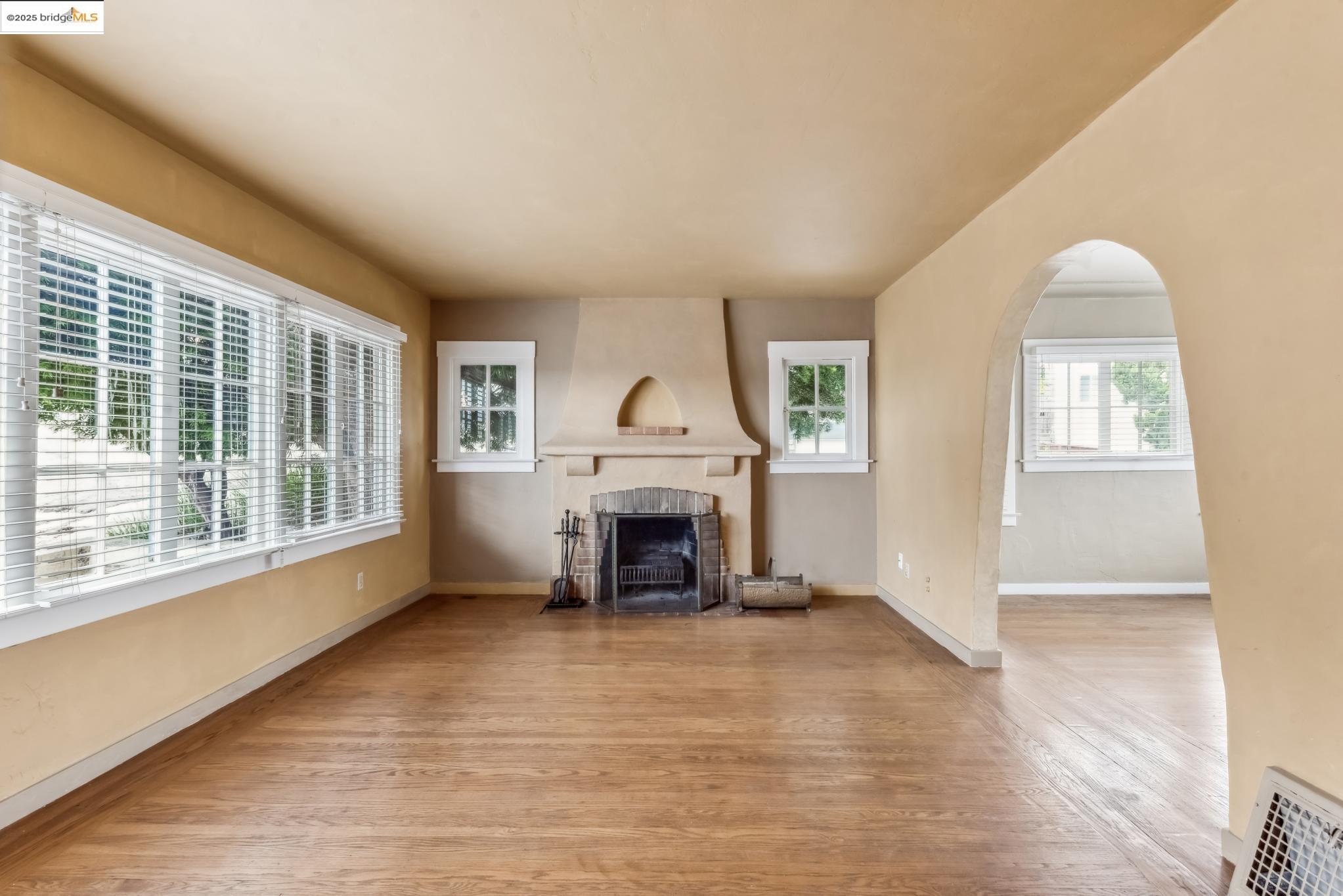 Undisclosed Address Oakland, CA 94610 - Photo 10 of 34 an empty room with furniture and a fireplace