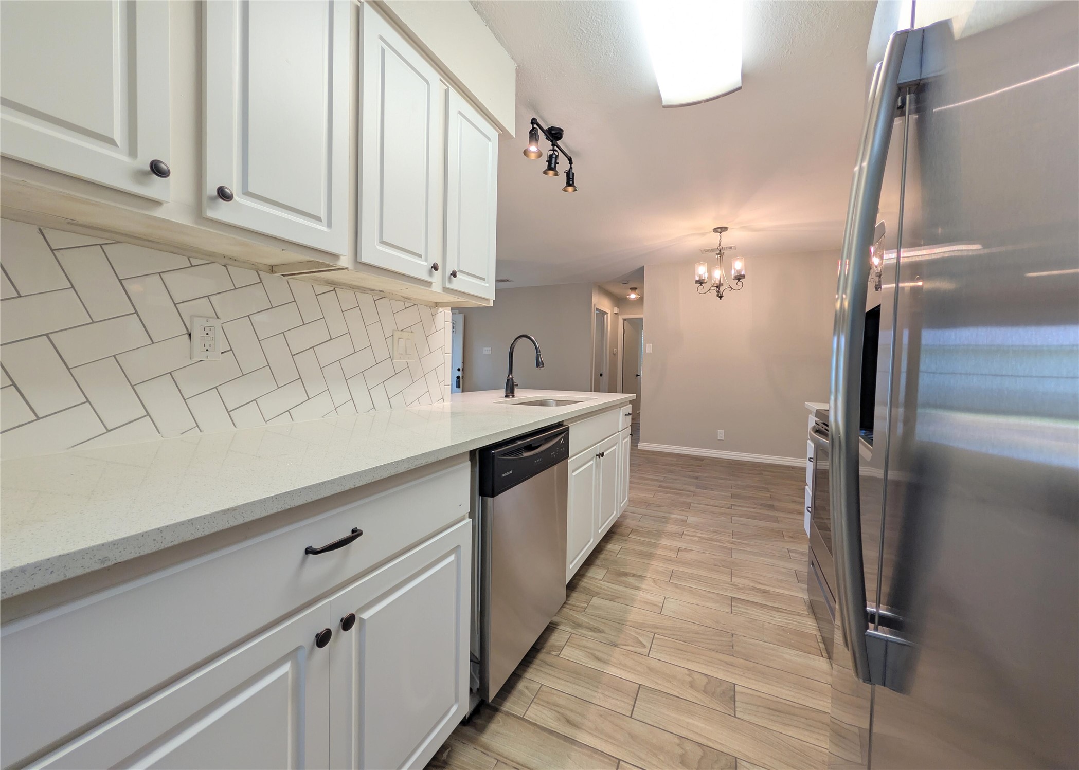 12601 Turtle Rock Road, Unit B Austin, TX 78729 - Photo 5 of 20 Stainless Steel appliances and large sink. Quartz countertops and tile backsplash and floor. Lots of cabinet space.