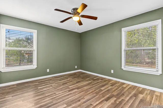 a view of a room with a window and a ceiling fan