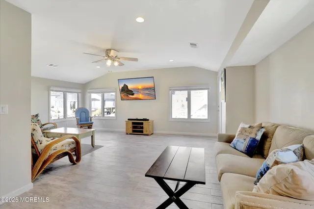 a kitchen with granite countertop a stove sink and microwave