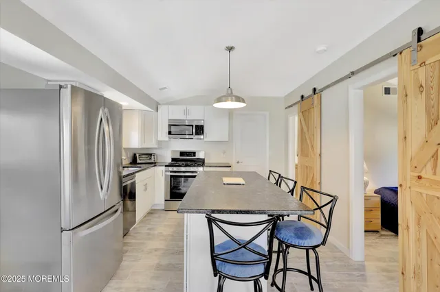 a kitchen with sink granite counter top space and living room