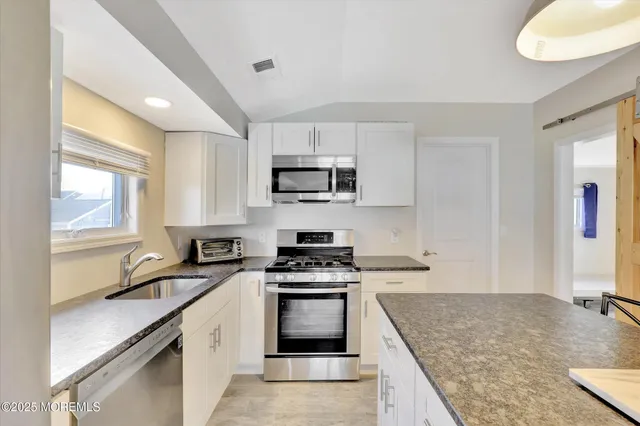 a view of a bedroom with window and ceiling fan