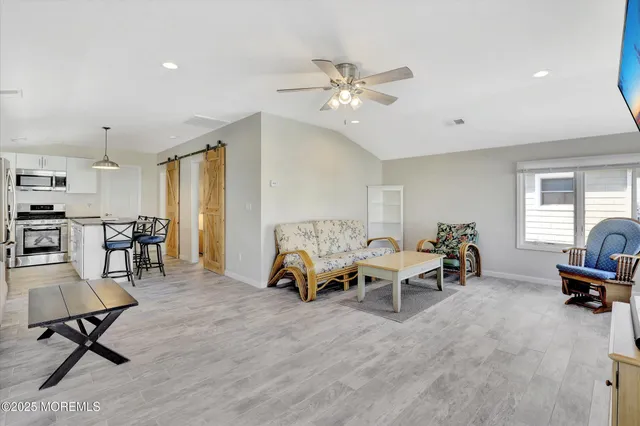 a living room with furniture and a gym machine
