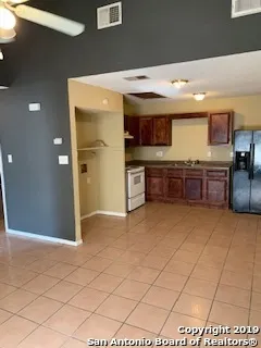 a large kitchen with stainless steel appliances granite countertop a sink and cabinets