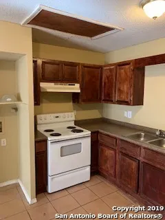 a kitchen with a stove and a microwave