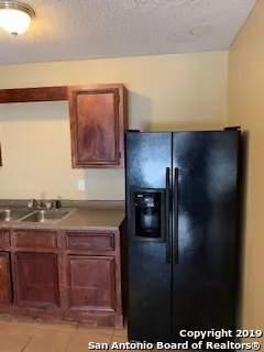 a kitchen with stainless steel appliances granite countertop a refrigerator and a stove