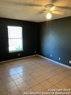 a view of a livingroom with an empty space and a window