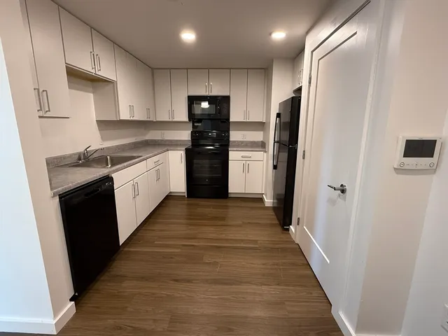 a kitchen with stainless steel appliances a refrigerator and a sink
