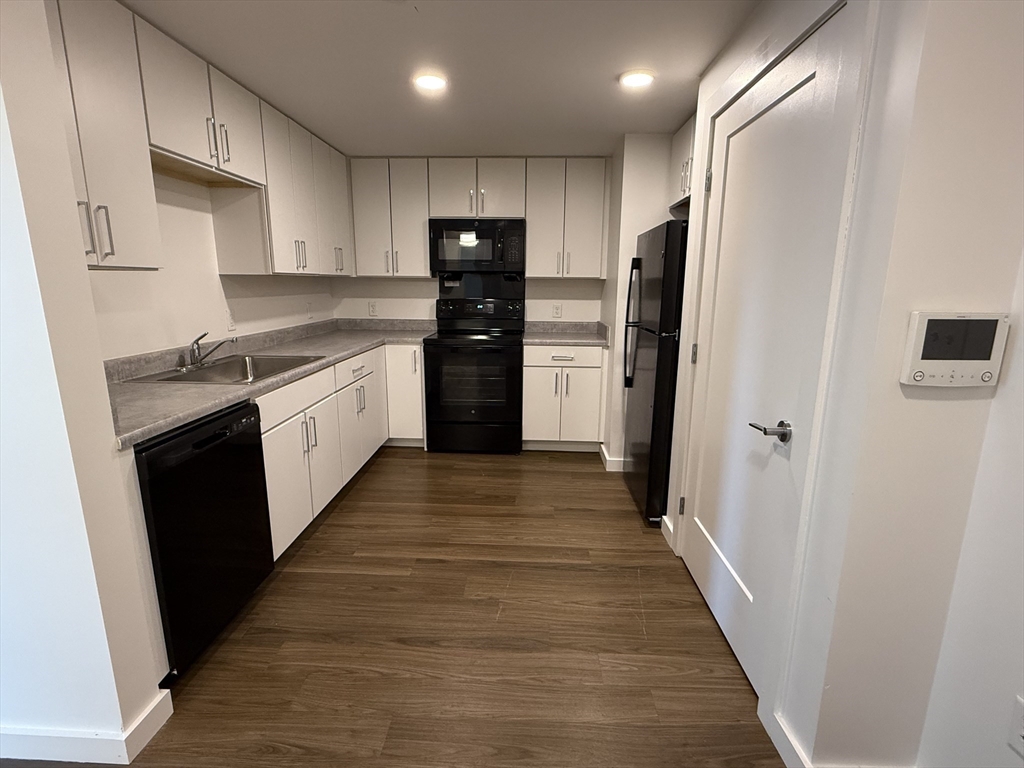 466 River Street, Unit 217 Boston, MA 02126 - Photo 2 of 18 a kitchen with stainless steel appliances a refrigerator and a sink