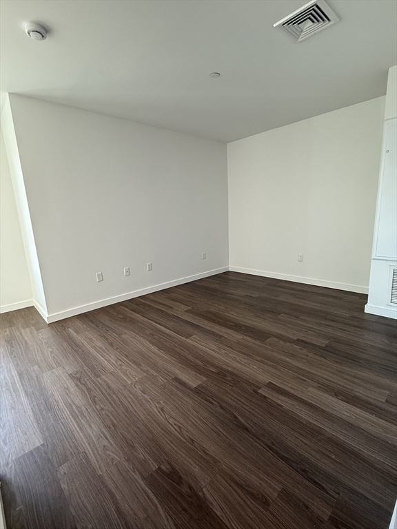 466 River Street, Unit 217 Boston, MA 02126 - Photo 3 of 18 a view of an empty room with wooden floor