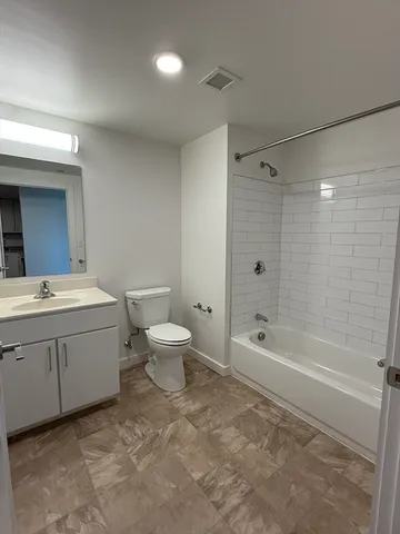 a bathroom with a double vanity sink toilet and shower