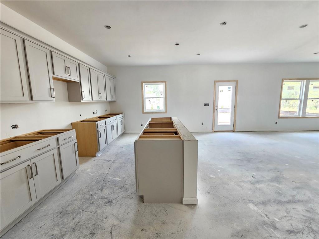 30 Silverleaf Trail Bethlehem, GA 30620 - Photo 11 of 55 a kitchen with stainless steel appliances granite countertop a stove top oven a sink a refrigerator and white cabinets