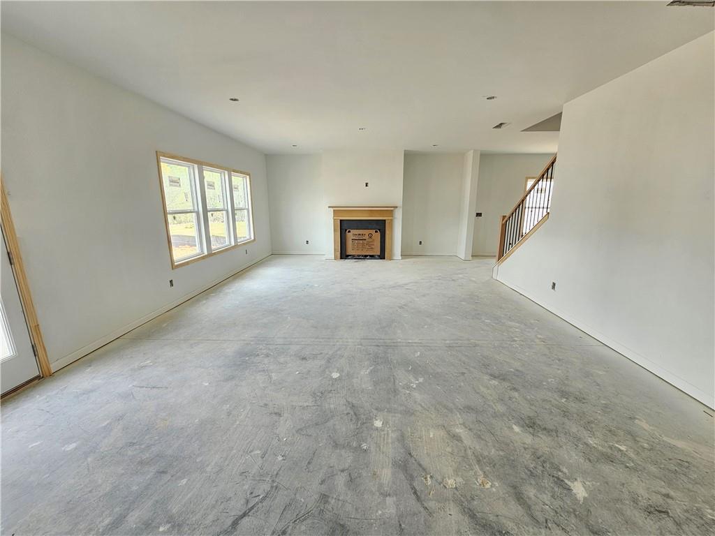 30 Silverleaf Trail Bethlehem, GA 30620 - Photo 14 of 55 a view of an empty room with a fireplace and windows