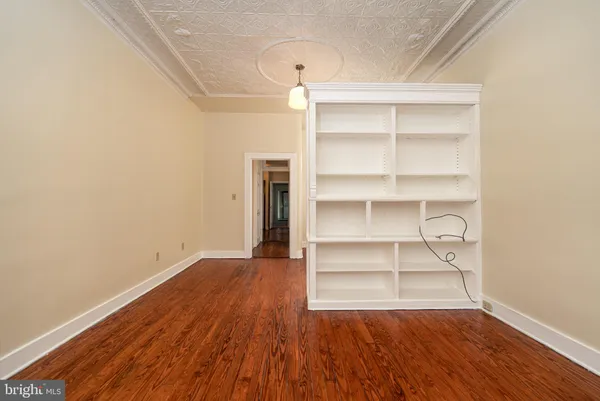 a view of a room with wooden floor and a window