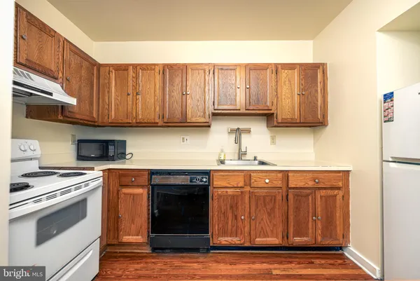a kitchen with stainless steel appliances granite countertop a stove and a sink