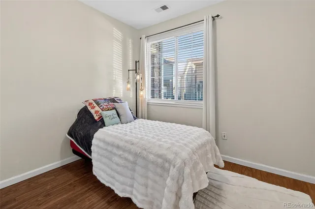 a bed sitting in a bedroom next to a window