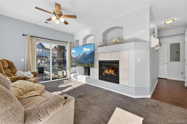 a living room with furniture and a fireplace