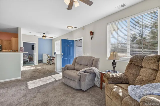 a living room with furniture and a large window