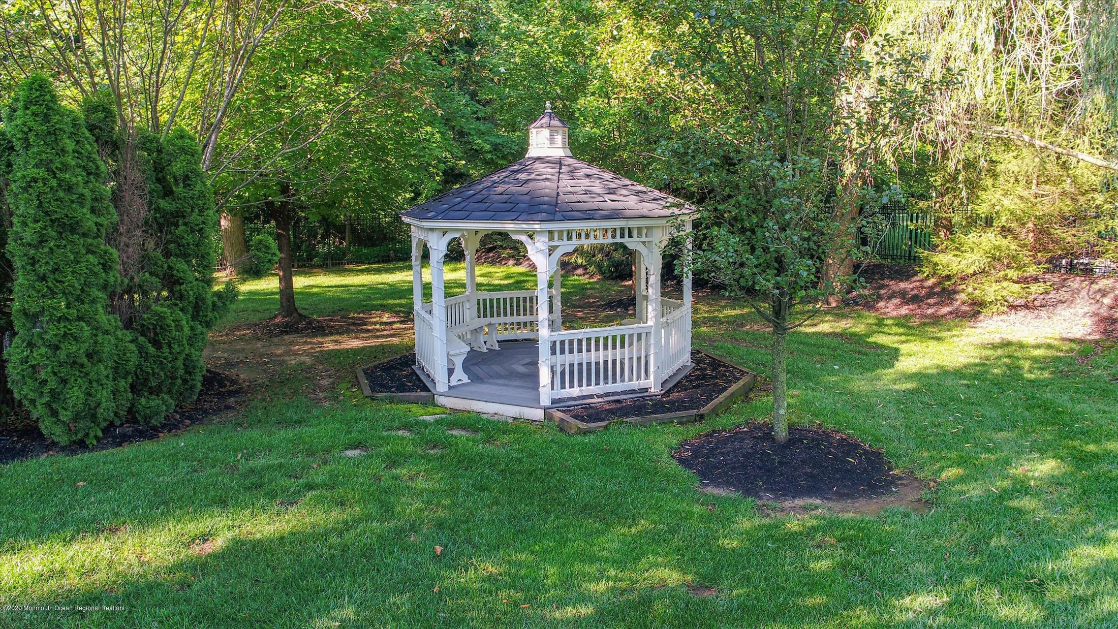 8 Maple Leaf Drive Holmdel, NJ 07733 - Photo 13 of 74 a backyard of a house with table and chairs