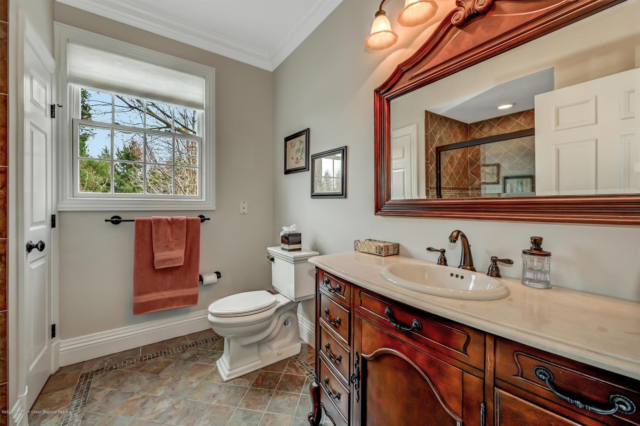 8 Maple Leaf Drive Holmdel, NJ 07733 - Photo 32 of 74 a bathroom with a sink a toilet and a mirror