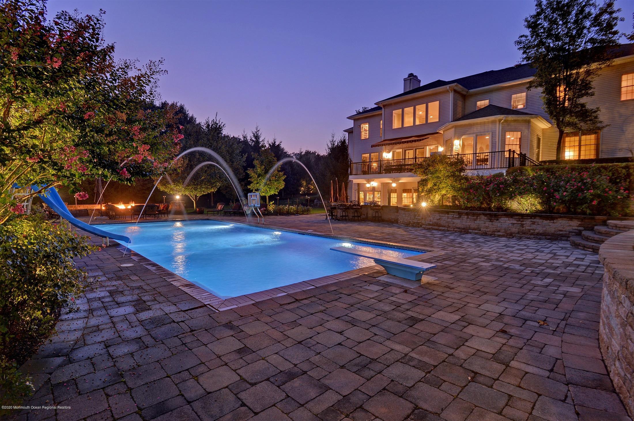 8 Maple Leaf Drive Holmdel, NJ 07733 - Photo 4 of 74 a front view of a house with garden