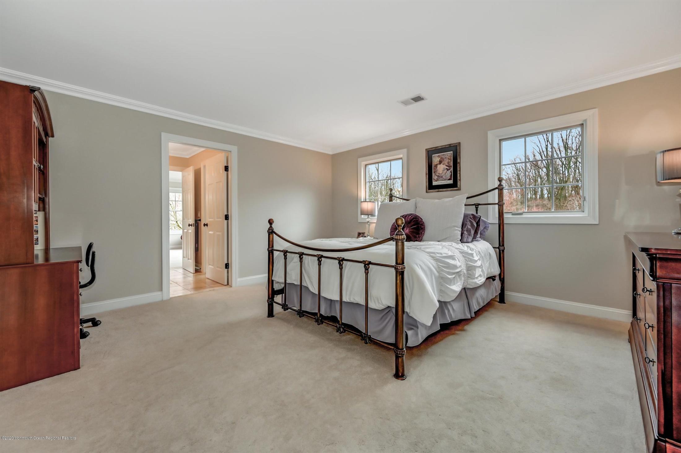 8 Maple Leaf Drive Holmdel, NJ 07733 - Photo 41 of 74 a bed sitting in a bedroom next to a window