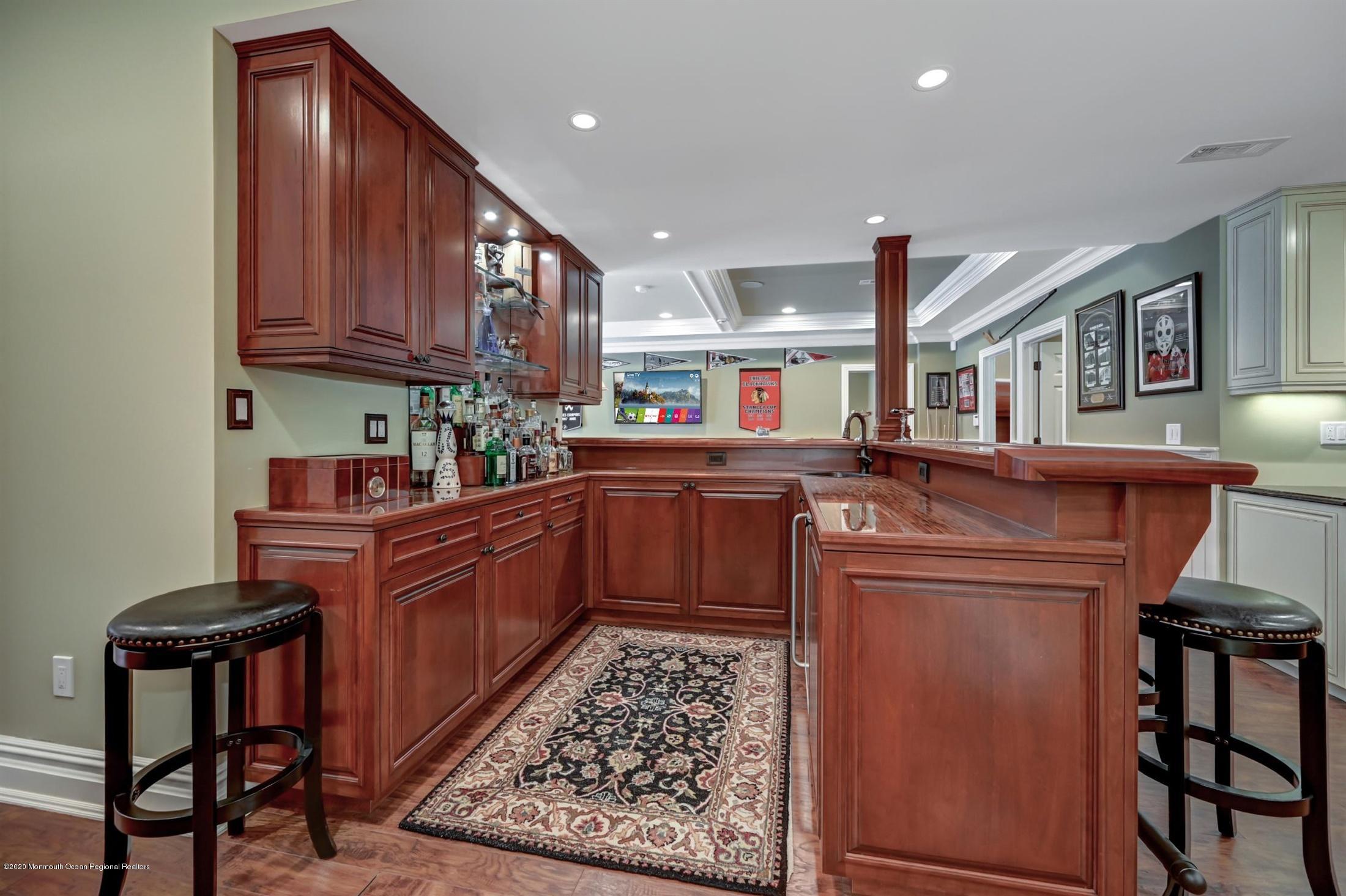 8 Maple Leaf Drive Holmdel, NJ 07733 - Photo 49 of 74 a kitchen with stainless steel appliances granite countertop a sink stove and wooden cabinets