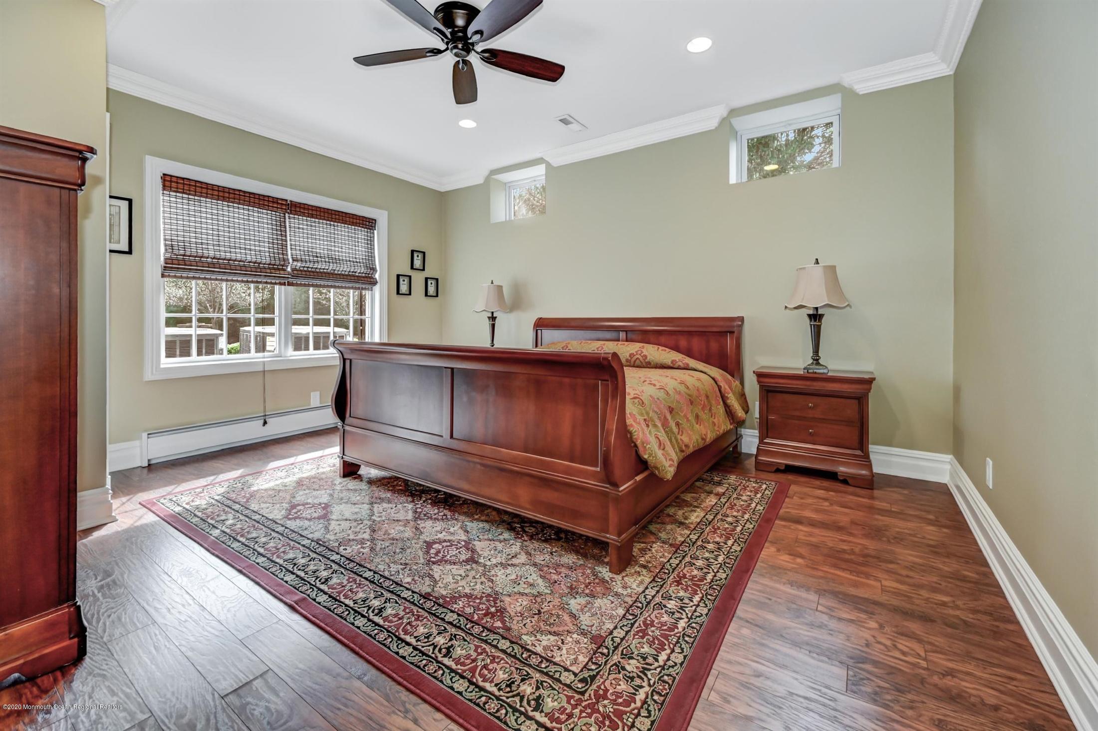 8 Maple Leaf Drive Holmdel, NJ 07733 - Photo 55 of 74 a bedroom with a bed lamp and a rug