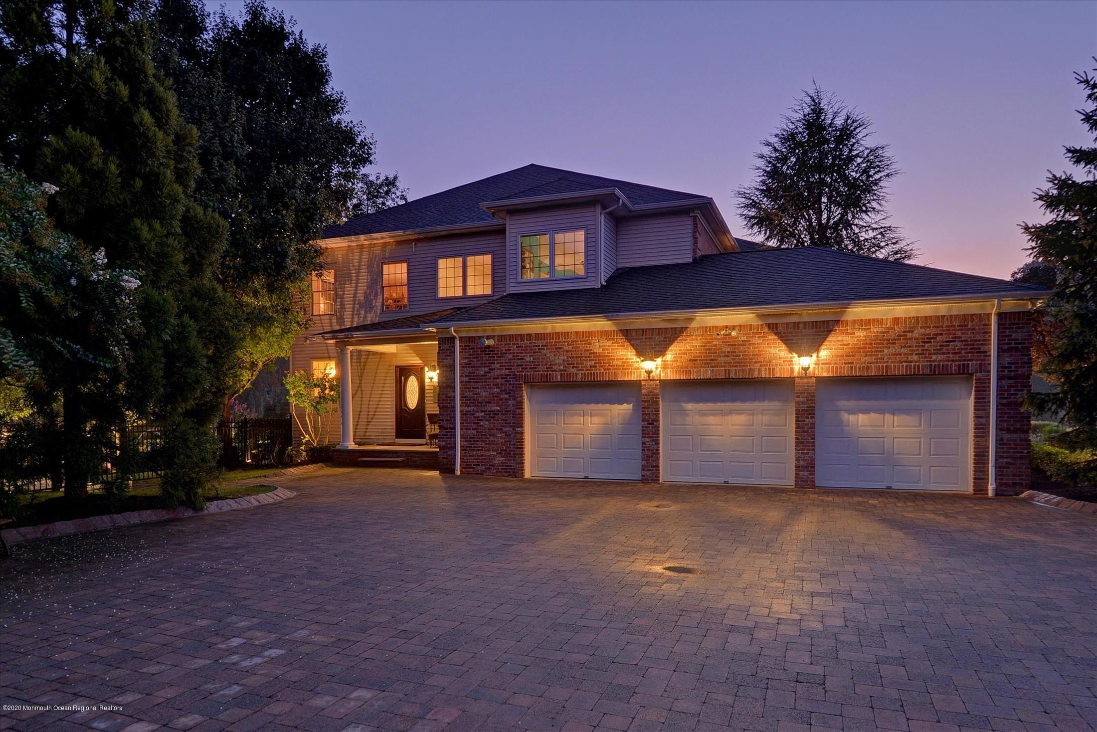 8 Maple Leaf Drive Holmdel, NJ 07733 - Photo 62 of 74 a front view of a house with a yard and garage