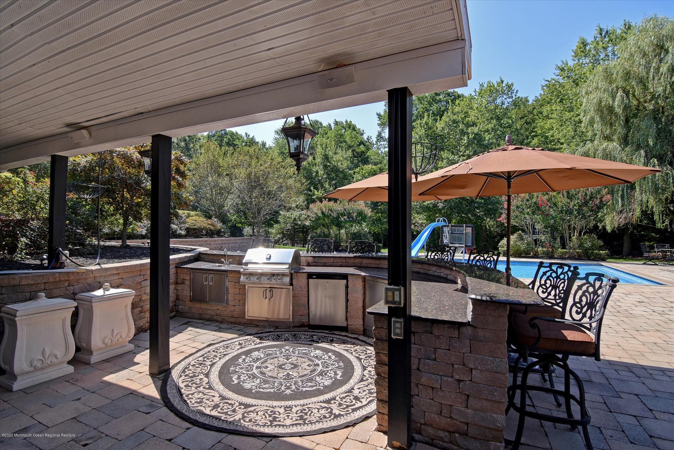 8 Maple Leaf Drive Holmdel, NJ 07733 - Photo 10 of 74 a view of a patio with furniture and wooden floor