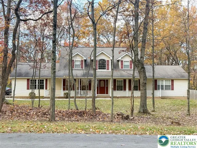 front view of a house with a tree