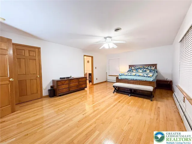 a spacious bathroom with a sink and a mirror